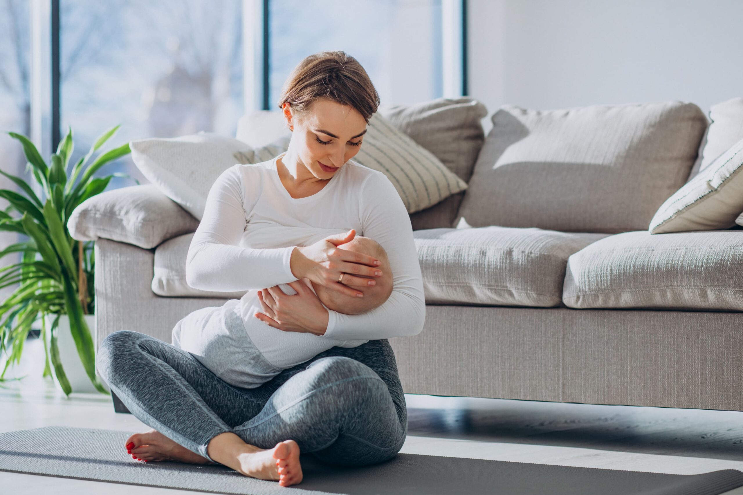 young-woman-breast-feeding-toddler-son-sitting-mat (1) tanda payudara kosong